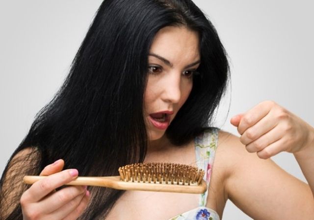 Lifestyle and Home Remedies for Hair Loss: A woman practicing stress management techniques, such as yoga and meditation, which can help in reducing hair loss caused by stress.