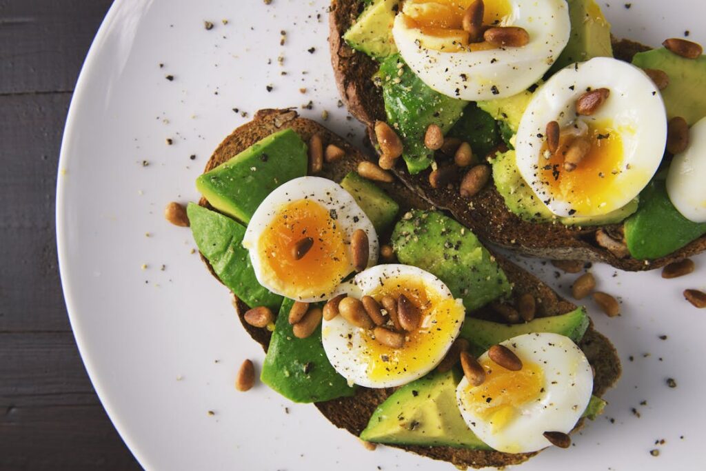 "An inviting breakfast spread consisting of oatmeal topped with fresh berries, a glass of orange juice, whole grain toast with avocado, and a side of Greek yogurt with honey, illustrating the concept that healthy food is good for breakfast."