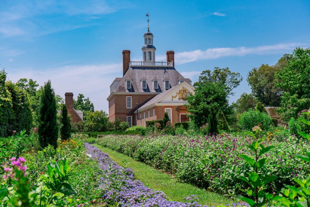 "Summer vacation in Williamsburg, Virginia, showcasing a family exploring the historical streets of Colonial Williamsburg with actors in period costumes demonstrating traditional crafts and activities."