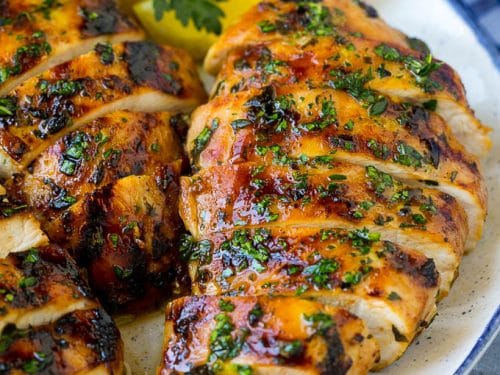 A beautifully grilled chicken breast, perfectly seasoned and garnished with fresh herbs, showcasing a delicious simple marinade. This image highlights the focus keyword "Chicken Breast Recipes," ideal for beginners seeking easy cooking inspiration.