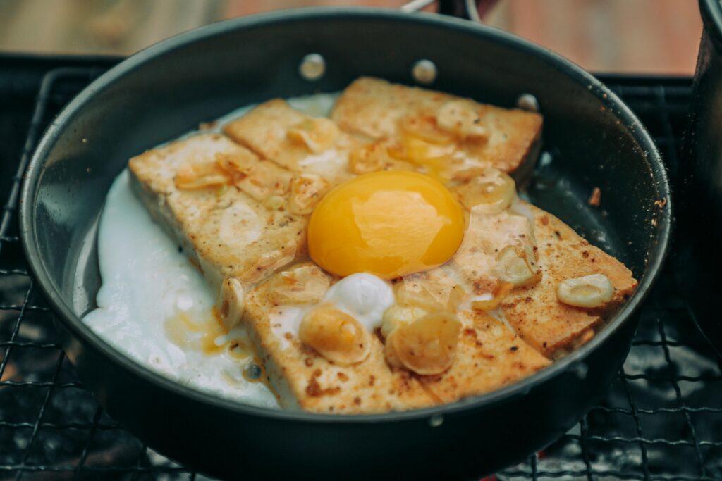 A well-seasoned griddle cooking golden French toast slices, showing the even browning and perfect texture. Opting for a non-stick pan or griddle ensures French toast is cooked evenly without sticking, resulting in a crispy outside and soft inside