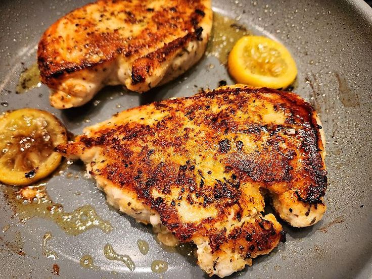 A beautifully cooked pan-seared chicken breast, golden brown and garnished with fresh herbs, served on a plate alongside vibrant vegetables. This dish is part of our collection of easy chicken breast recipes for beginners, showcasing simple cooking techniques and delicious flavors.