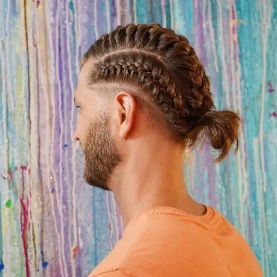 A man with bold and elevated Dutch Braids, showcasing a stylish, three-dimensional look. Perfect example of trendy Braids for Men.