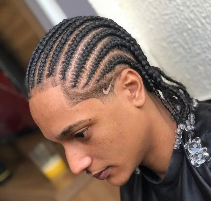 A man wearing sleek, intricate Fishtail Braids for Men, showcasing an edgy and modern look perfect for adding texture and style to long hair.