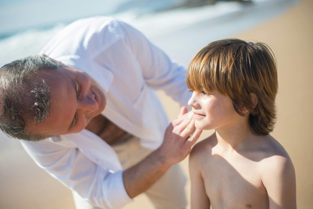 "Family applying sunscreen to protect their skin during a sunny day at one of the best vacation spots."