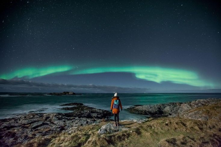 "Stunning view of the Northern Lights illuminating the night sky over Tromsø, Norway, showcasing one of the best vacation spots for experiencing this natural phenomenon."