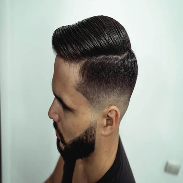 Feature image showcasing a sharp and bold undercut hairstyle for men, highlighting a clean fade and slicked-back top for a stylish, modern look. This trendy example emphasizes the versatility of popular Hairstyles for Men with a bold edge