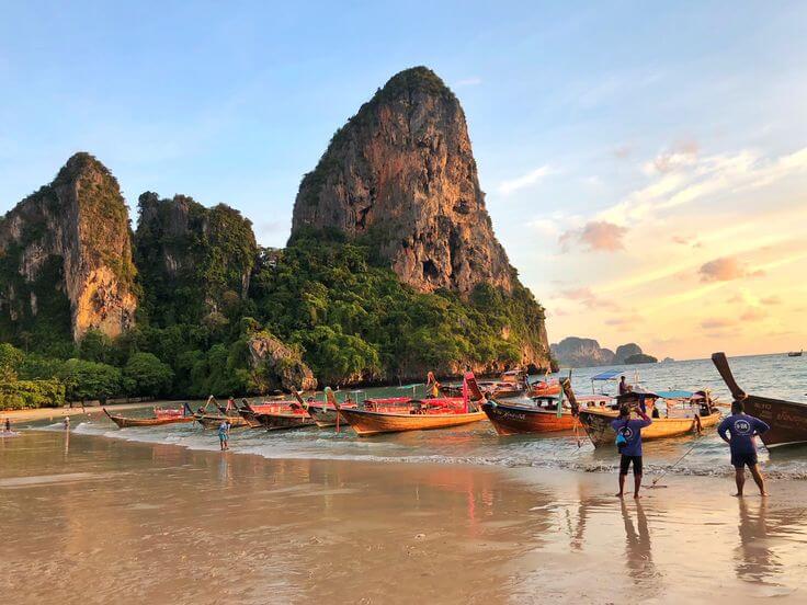 A breathtaking view of Railay Beach in Krabi, Thailand, one of the Best Beaches in the World, with its stunning limestone cliffs, clear turquoise waters, and soft white sand.